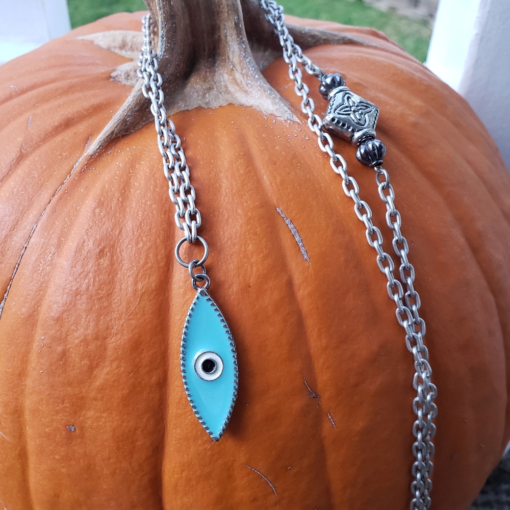 Long blue evil eye pendant on silver necklace